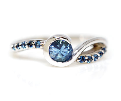 custom designed montana blue sapphire and london blue topaz white gold swirl bezel ring