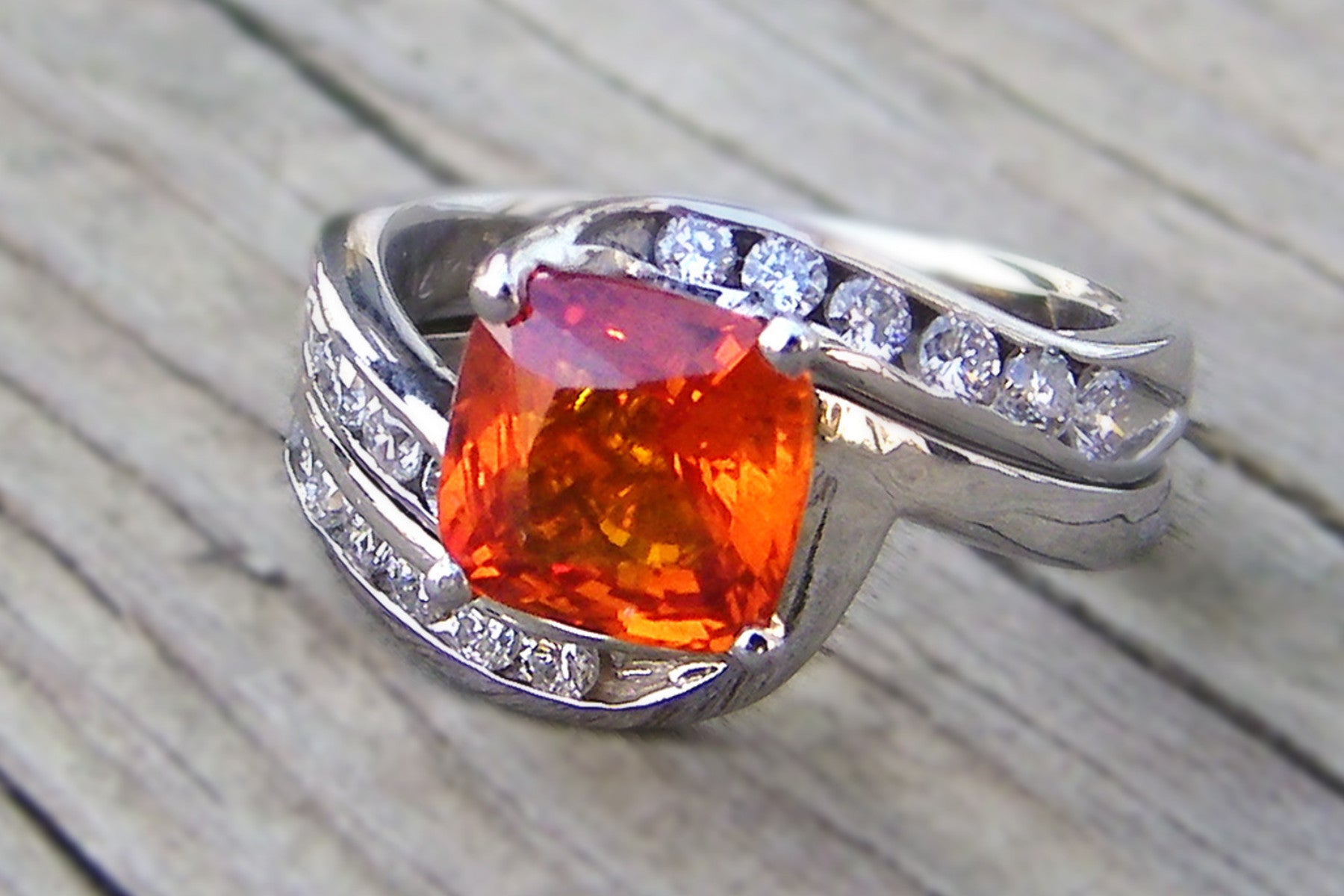 cushion cut orange sapphire and diamond bypass wedding ring
